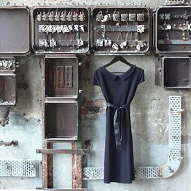 LBD/ black dress to old meter case in old urban factory. by Tineke Bos