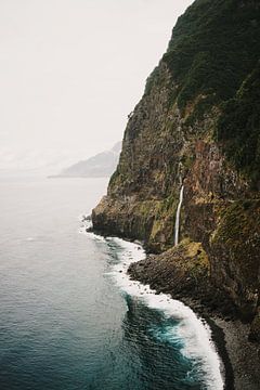 Waterfall along rocky coast Seixal Beach Madeira