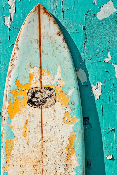 Worn surfboard in front of a blue wall by Poster Art Shop