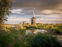 Trio de moulins au coucher du soleil