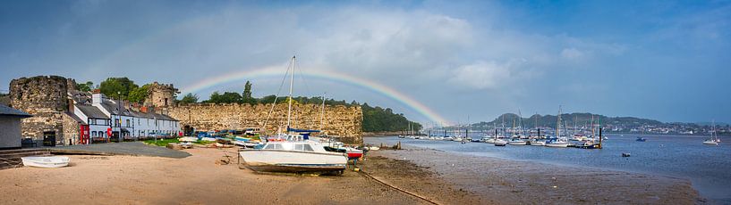 Rainbow over the beach and the city walls of Conwy, Wales by Rietje Bulthuis
