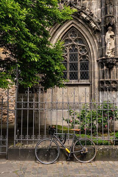 bicycle against fence by Joes van Asten