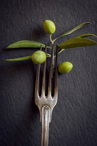 old silver fork with olives by Elly de Vries