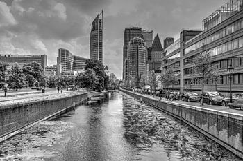 Hague canal with view of high-rise buildings