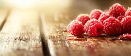 Fresh raspberries on a wooden background by Poster Art Shop
