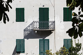 A balcony casting its shadow on a listed building in Lucca, Tuscany, Italy. (colour)