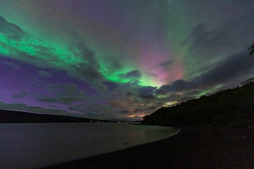Northen light under mountains. Beautiful natural landscape in the Iceland