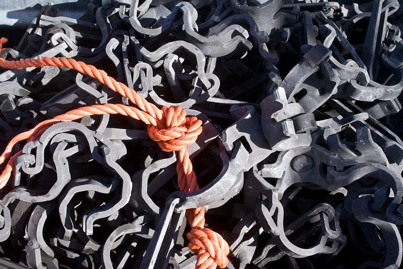 Orange rope between metal by Mark Nieuwenhuizen