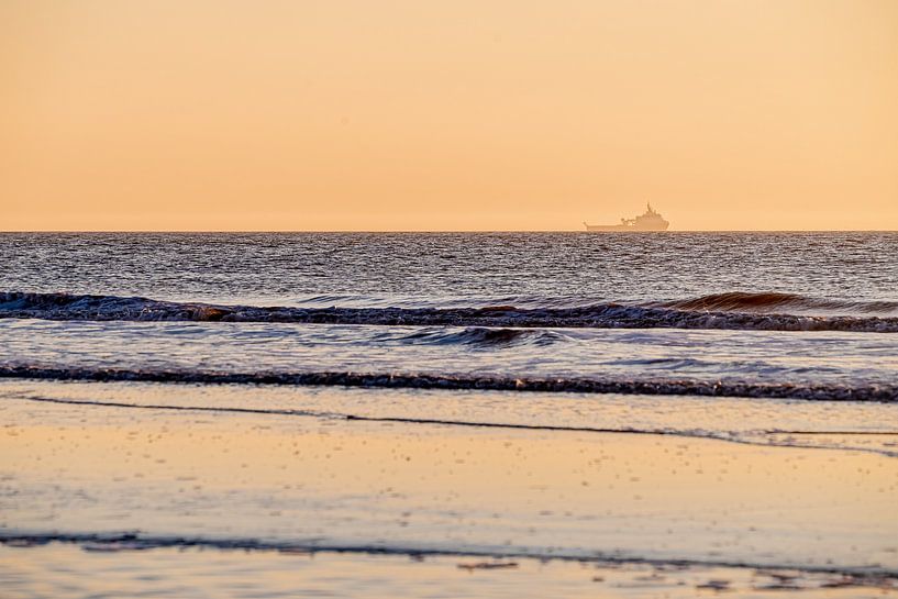 Ship on the North Sea during sunset by Rutger van der Klip