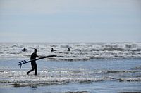 A surfer on the beach