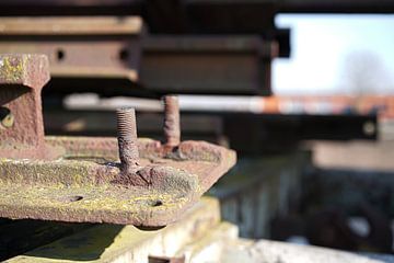 Screw with thread on a rusted component at a scrap yard by Heiko Kueverling