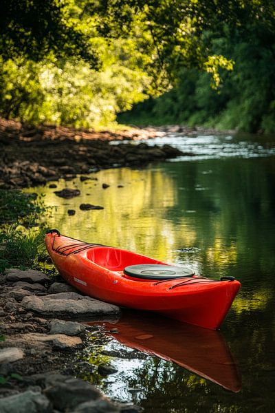 Red kayak on the calm riverbank by Poster Art Shop