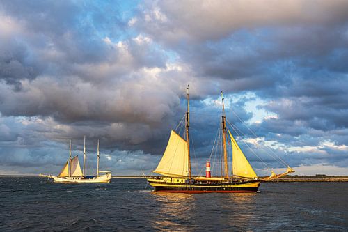 The windmill tower and sailing ships on the Baltic Sea in Warnemünde by Rico Ködder