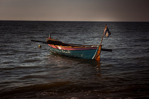 A dinghy bobs in the evening sun