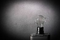 Glühbirne Schuss durch eine Kugel gegen grauen Hintergrund von pixxelmixx Miniaturansicht