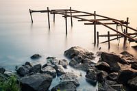 Old broken jetty in the river Lek in The Netherlands