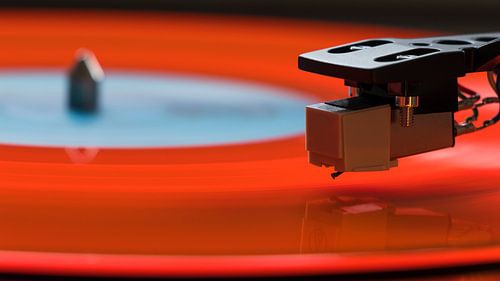 Orange long-playing disc on record player