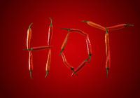 The word Hot written with chili peppers against red gradient bac