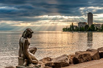 Small statue of a bather on Lake Leman (Switzerland). by Carlos Charlez