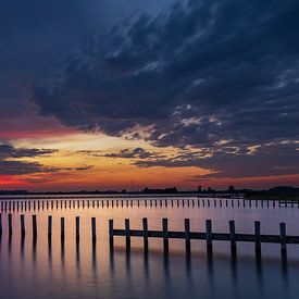 Reflection of poles during sunset by StephanvdLinde