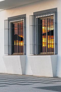 Sunset reflected in a window of a white façade. Rota, Costa de la Lutz, Cádiz, Andalusia, Spain