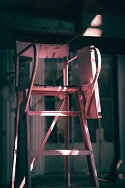 Pink umpire seat in an old factory hall by Roel Timmermans