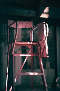 Pink umpire seat in an old factory hall by Roel Timmermans
