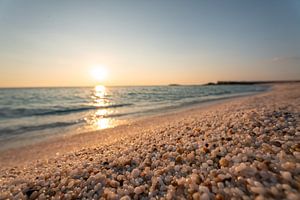Risotto Reis Strand Is Arutas auf Sardinien zum Sonnenuntergang mit glitzerndem Meer und Steinen