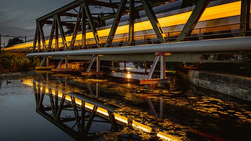 Train over bridge in the evening