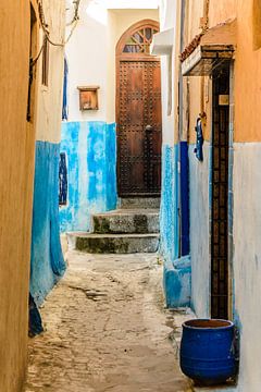 Narrow alley with brown door in medina of rabat in morocco by Dieter Walther