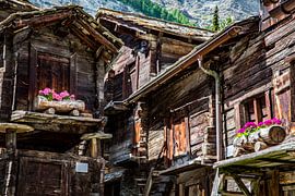 Historic wooden chalets with geraniums in Zermatt by Patrick Kilb