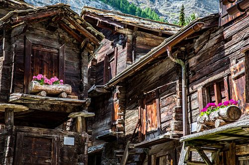 Historic wooden chalets with geraniums in Zermatt