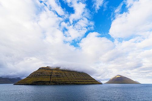 Uitzicht op de rotsen van de Faeröer met wolken van Rico Ködder