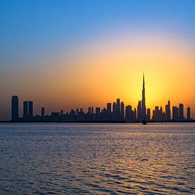 Dubai skyline by warm sunset
