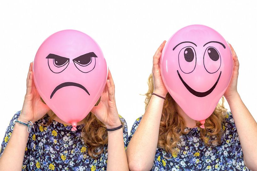 Two girls holding pink balloons with facial expressions by Ben Schonewille