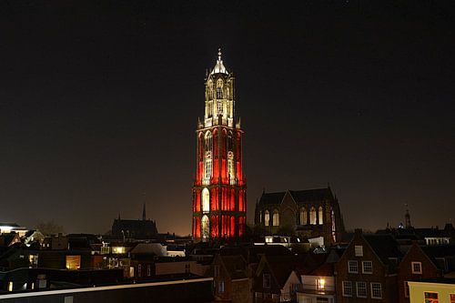 Skyline of Utrecht with red and white lit Dom tower.