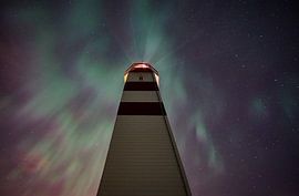 The Alnes lighthouse points out the northern lights by qtx