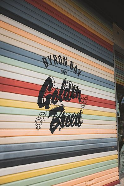 Colourful garage door of a surf school by Ken Tempelers