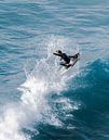 Pro Surfer flying high out of a wave by massimo pardini thumbnail
