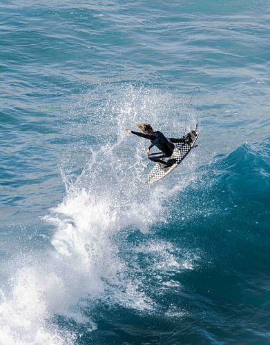 Un surfeur pro qui vole haut dans la vague