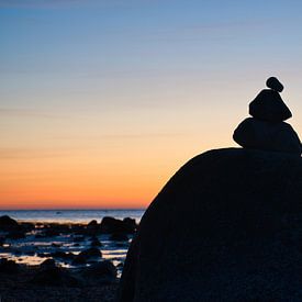 Stone pyramid on the Baltic Sea with a view of the sea at sunset and blue hour by Martin Köbsch