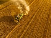 Combine oogst graan in de zomer gezien van bovenaf van Sjoerd van der Wal Fotografie thumbnail