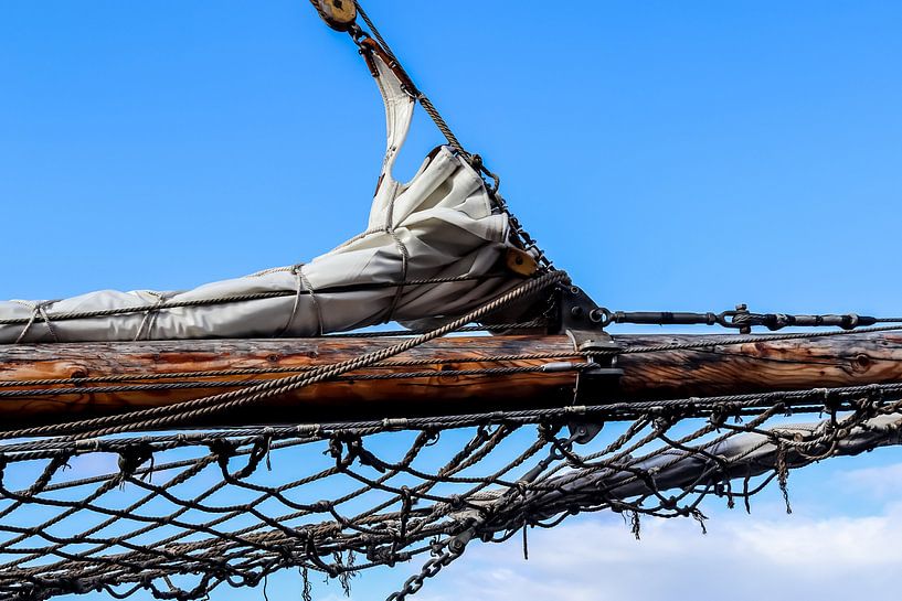 Sailing mast with many ropes in front of a blue sky by MPfoto71