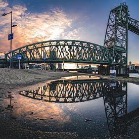 Reflection of the Hefbrug in Rotterdam in a pool of water by Arthur Scheltes
