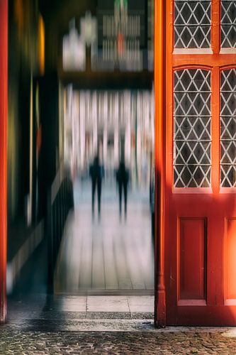 Red open door in Bruges