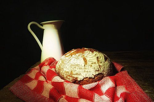 Stilleven met broodmik en geblokt kleedje .