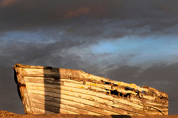 Old abandoned, rotten boat on the beach