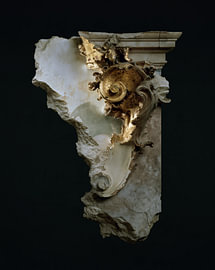 What remains: a weathered golden ornament on a dark wall by Dutch Art Works