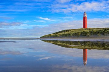 Texel lighthouse at the beach during a calm autumn afternoon wit