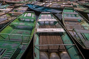 Painted metal rowboats in a row by Sander Groenendijk
